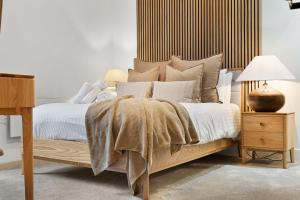 a bedroom with a bed with a wooden headboard at Rock Mill Apartment 8 in Eyam