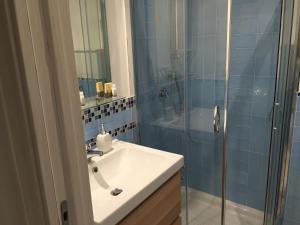 a bathroom with a sink and a glass shower at Appartamento 403 in Messina