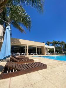 a group of lounge chairs next to a swimming pool at Complejo Tajamar in Colón