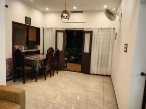 a dining room with a table and chairs at Gerards Home stay Fortkochi in Cochin +41 photos