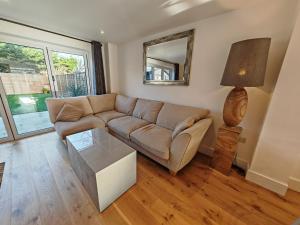 a living room with a couch and a mirror at Middleton in Bognor Regis