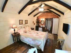 um quarto com uma cama e uma ventoinha de tecto em Tiny Home Cottage Near the Smokies #8 Helga em Sevierville