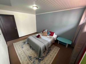 a small bedroom with a bed and a table at Beautiful house in The center of San Ramón in San Ramón