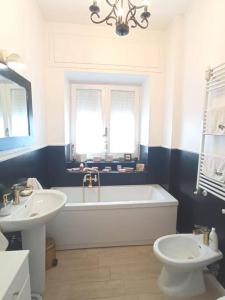 a bathroom with a tub and a toilet and a sink at Rooftop Appia antica, Attico silenzioso residenziale in Rome