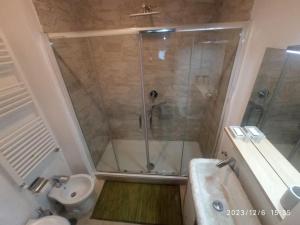 a bathroom with a shower and a toilet and a sink at Rooftop Appia antica, Attico silenzioso residenziale in Rome