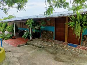 a house with a porch and a garage at Hostal Sol de Verano Doña Lilia in Villavieja