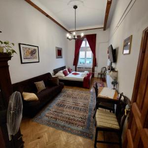 uma sala de estar com um sofá e uma cama em Classical Budapest apartment in the old Pest em Budapeste
