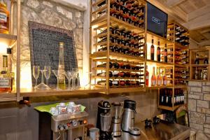a bar with a bunch of bottles of wine at Georgia's Garden by Omilos Hotels in Amoudara Herakliou