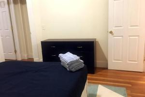 a bedroom with a bed and a black dresser at Comfy 4 Bed 1 Bath w/ Wi-fi in College Area in Springfield