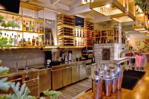 a large kitchen with a counter and a bar at Georgia's Garden by Omilos Hotels in Amoudara Herakliou