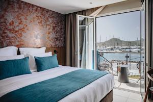 勒马兰Sable Bleu Boutique Hotel的一间带大床的卧室和一个阳台