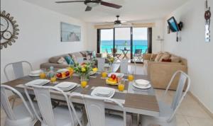 a dining room and living room with a table and chairs at Perfect vacation getaway,Ocean View,Wifi, Beach in Cancún