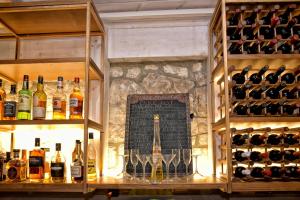 a bar with bottles and glasses of wine at Georgia's Garden by Omilos Hotels in Amoudara Herakliou