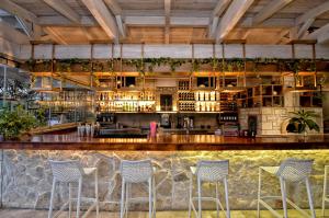 a bar with blue chairs in a restaurant at Georgia's Garden by Omilos Hotels in Amoudara Herakliou