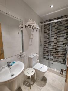 a bathroom with a sink and a toilet and a shower at Hostal Rioja Condestable in Logroño
