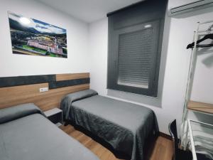 Postel nebo postele na pokoji v ubytování Hostal Rioja Condestable