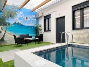 a house with a swimming pool and a table and chairs at Apartamento en la Gran Manzana in Valencia
