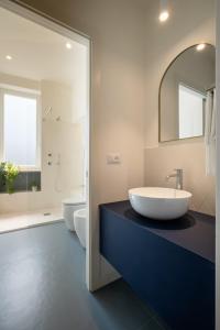 a bathroom with a large white sink and two toilets at Realkasa Gallery Blue Suite in Bologna