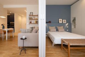 a bedroom with a large bed and a dining room at Realkasa Gallery Blue Suite in Bologna +10 photos