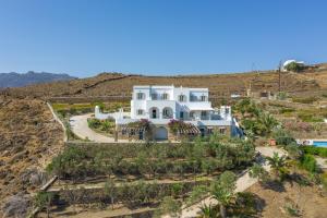 an aerial view of a white house on a hill at La Chapelle Ouest in Agios Romanos