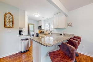 a kitchen with white cabinets and a counter top at Maple Leaves - 30 Day Rental in Charleston