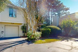a house with a tree in front of a driveway at Maple Leaves - 30 Day Rental in Charleston
