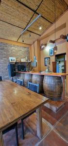 a room with a bar with a wooden table and chairs at Uspallata Suites in Uspallata