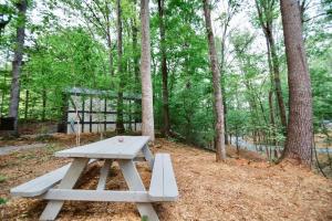 a picnic table in the middle of the woods at Tiny Home Cottage Near the Smokies #9 Frieda in Sevierville