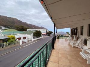 a balcony of a building with a view of a street at Le Bay Lodge in Gordonʼs Bay