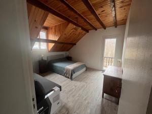 a bedroom with a bed and a wooden ceiling at Chalet d’Ax Pyrénées in Ax-les-Thermes