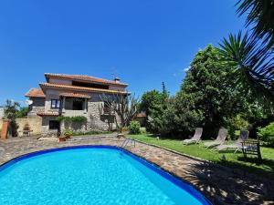 a swimming pool in front of a house at Casa do Faial - Braga in Braga