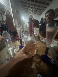 a person holding up a bottle of champagne at a table at Villa Aratoca suíte presidencial in Garça