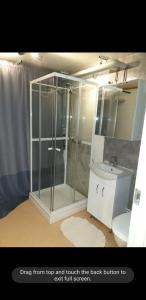 a bathroom with a shower and a toilet and a sink at Trondheim, Kroppanmarka Tiller in Trondheim
