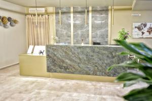 a lobby with a large marble counter in a room at Georgia's Garden by Omilos Hotels in Amoudara Herakliou