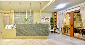 a lobby with a large marble counter in a room at Georgia's Garden by Omilos Hotels in Amoudara Herakliou