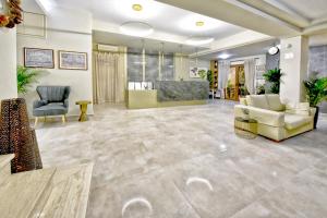 a large lobby with two chairs and a couch at Georgia's Garden by Omilos Hotels in Amoudara Herakliou