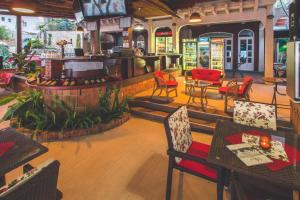 a restaurant with tables and chairs and a bar at Apartments Deus in Dobra Voda