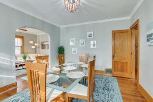 a dining room with a glass table and chairs at Pet-Friendly Omaha Vacation Rental with Deck! in Omaha