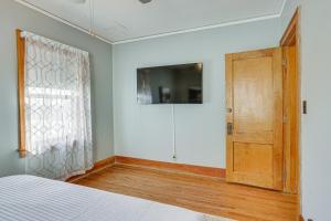 a bedroom with a bed and a wooden door at Pet-Friendly Omaha Vacation Rental with Deck! in Omaha