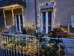 a house with christmas lights on the front porch at HomeStory 3 in Casa Canovetta
