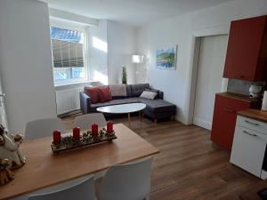 a living room with a couch and a table at HeimatHerz Hotel Garni in Herdecke