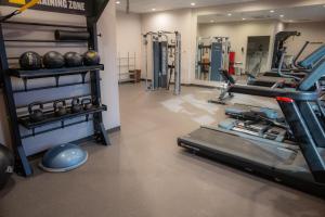 a gym with a treadmill and lots of exercise equipment at Hotel 620 in Hagerstown