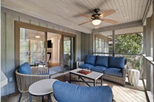 een woonkamer met een blauwe bank en stoelen bij 4134 Bulrush in Kiawah Island