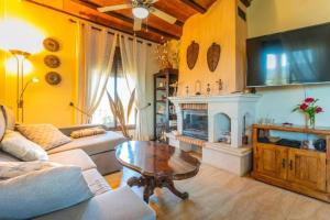 a living room with a table and a fireplace at finca mallorquin in Málaga