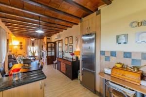 a kitchen with a refrigerator and a dining room at finca mallorquin in Málaga