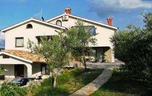 a white house with a car parked in front of it at Farm stay Domačija Butul in Koper