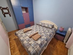 a small bedroom with a bed with two towels on it at Malina in Belgrade