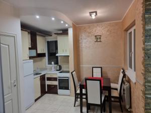 a small kitchen with a table and chairs at Malina in Belgrade