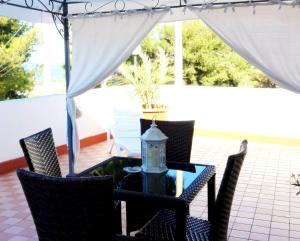 a patio with a table with chairs and a lantern at Residence Maresol in Vieste