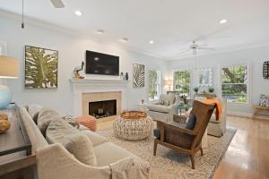 a living room with a couch and a fireplace at 23 Ocean Green in Kiawah Island